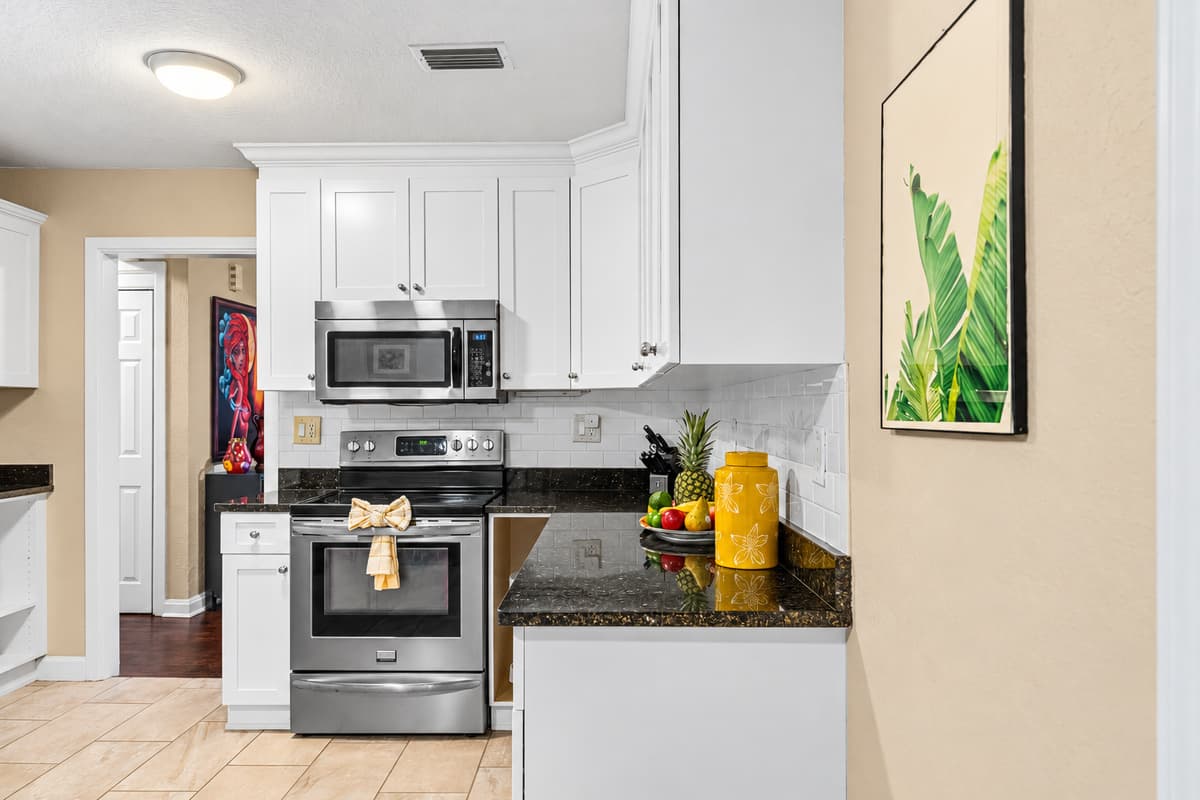 Fully equipped kitchen with oven, microwave, and essentials—ideal for home-cooked meals.