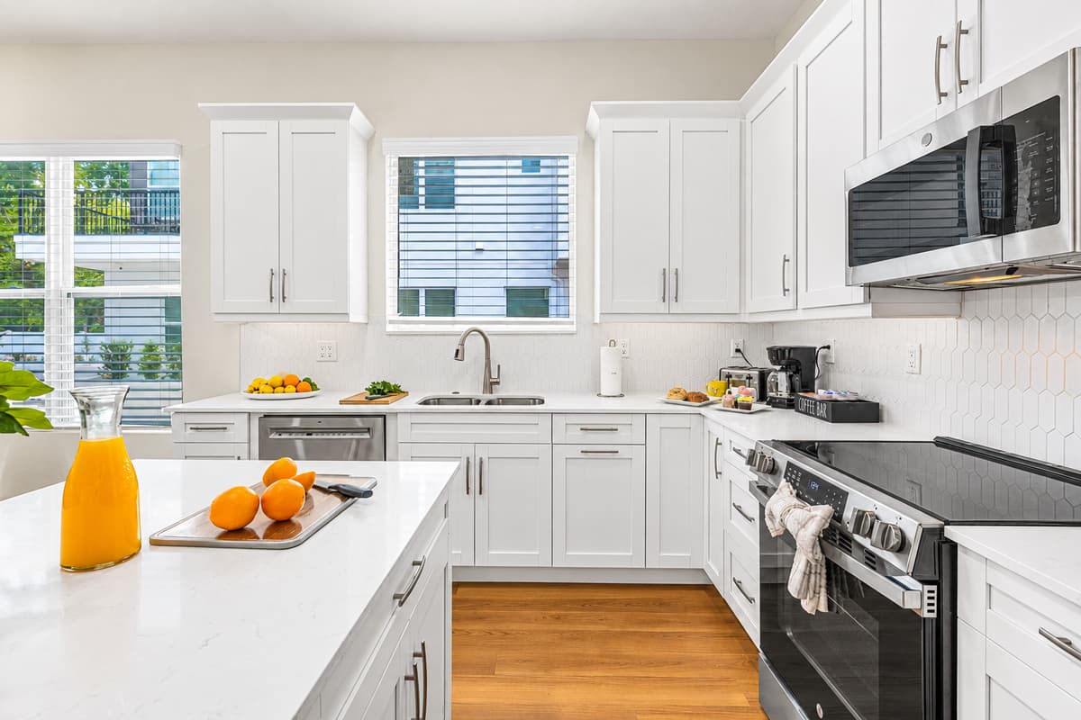 Modern kitchen with sleek white cabinetry, large island, and plenty of prep space.