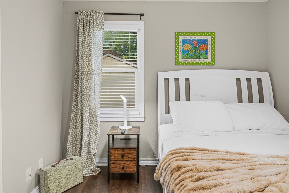 Cozy bedroom with comfortable bed, soft linens, and natural light—perfect for a restful stay.