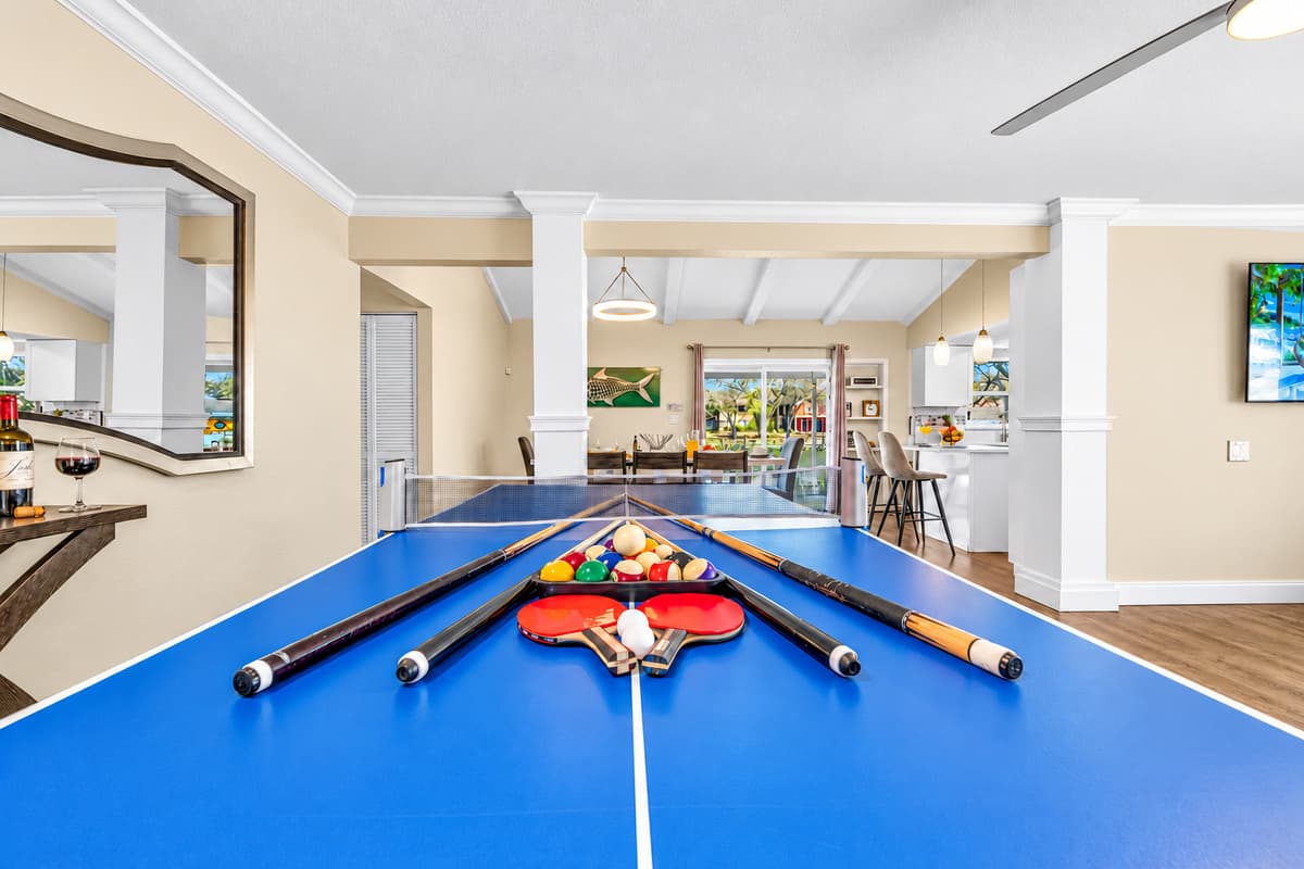 Spacious recreation area with pool table and seamless access to the kitchen and dining room.