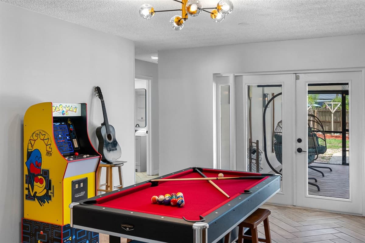 Challenge your group to a friendly game of ping pong or Pac-Man in this vibrant game room, complete with a built-in bar and stylish lighting that sets the mood.