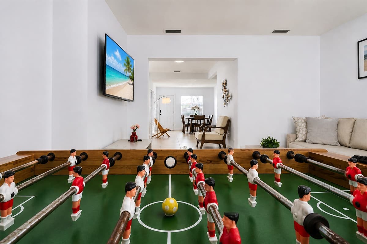 Entertainment room with foosball table, smart TV, and spacious open-concept layout.