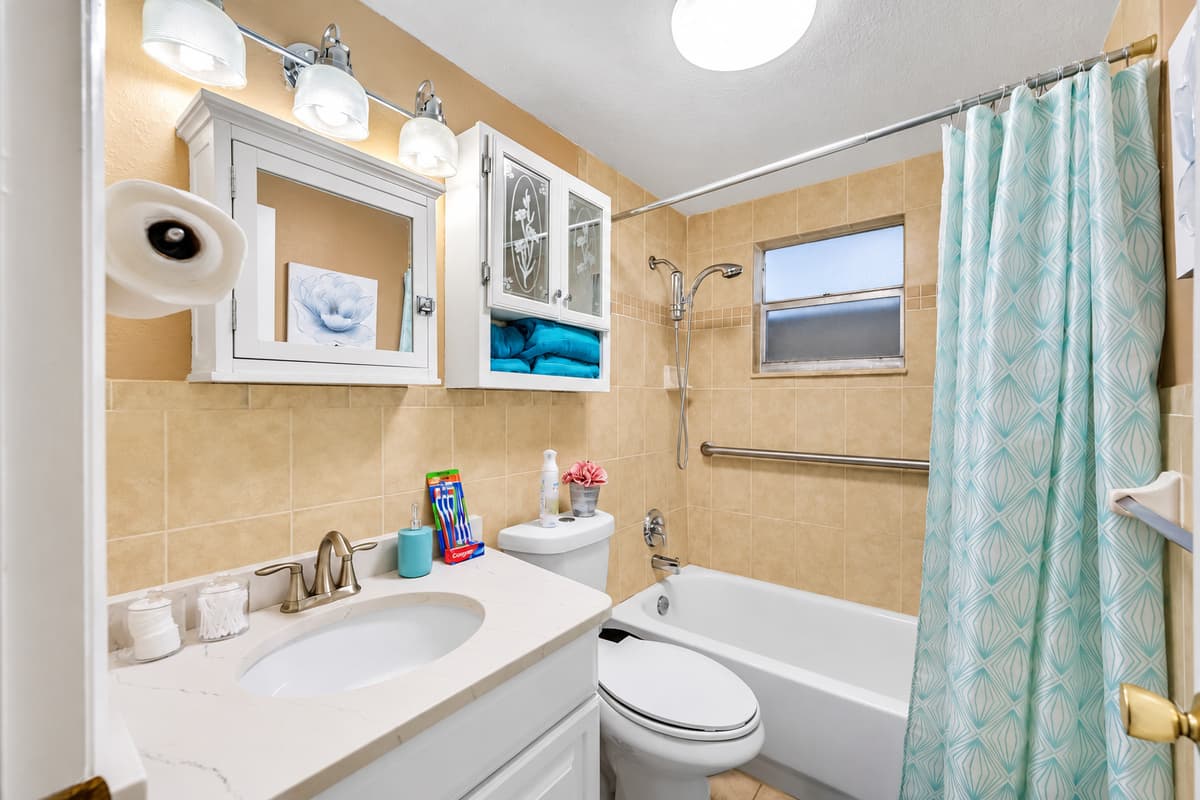 Spacious bathroom equipped with bathtub, sink, toilet and shower. Enjoy a relaxing bath after a long day of travel from your home to your home away from home. If you think this property if for you, send us an inquiry right away!