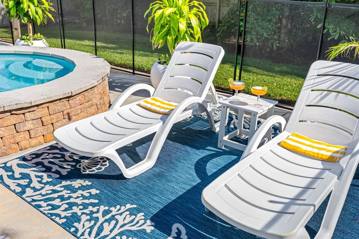Multiple chaise loungers for sunbathing, reading, or sipping poolside drinks.