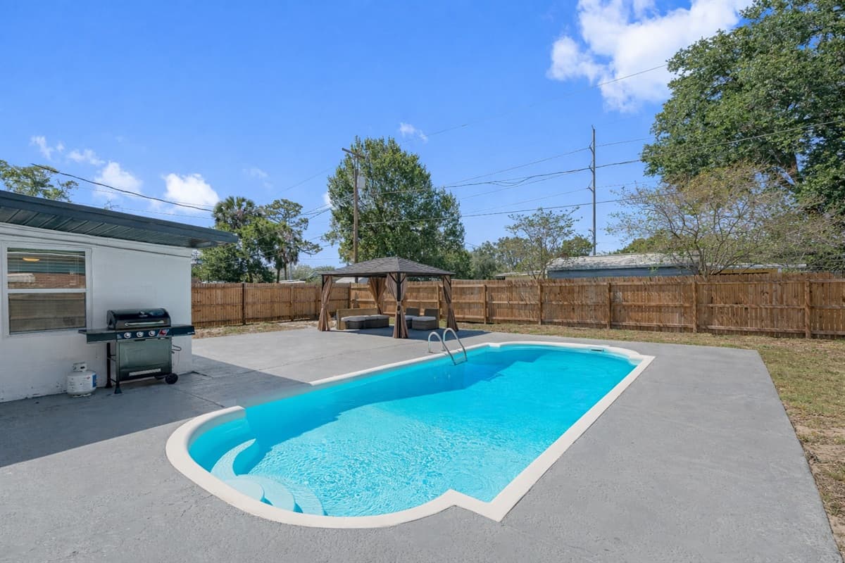 The crystal-clear waters of the pool invite you to take a refreshing dip, while the surrounding lounge chairs and sunbeds offer a front-row seat to the beauty of the outdoors.