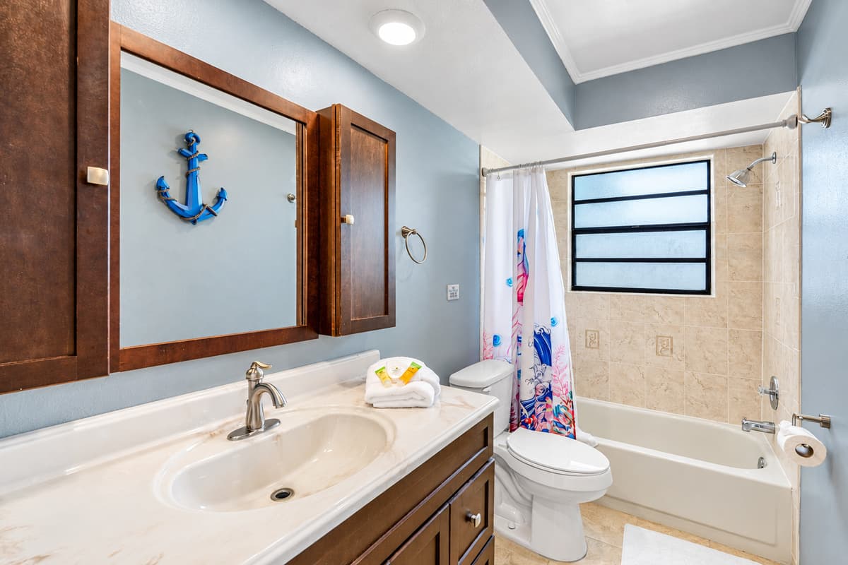 Soft, overhead lighting complements the natural light streaming in from the frosted privacy window, creating a bright yet soothing environment throughout the day.