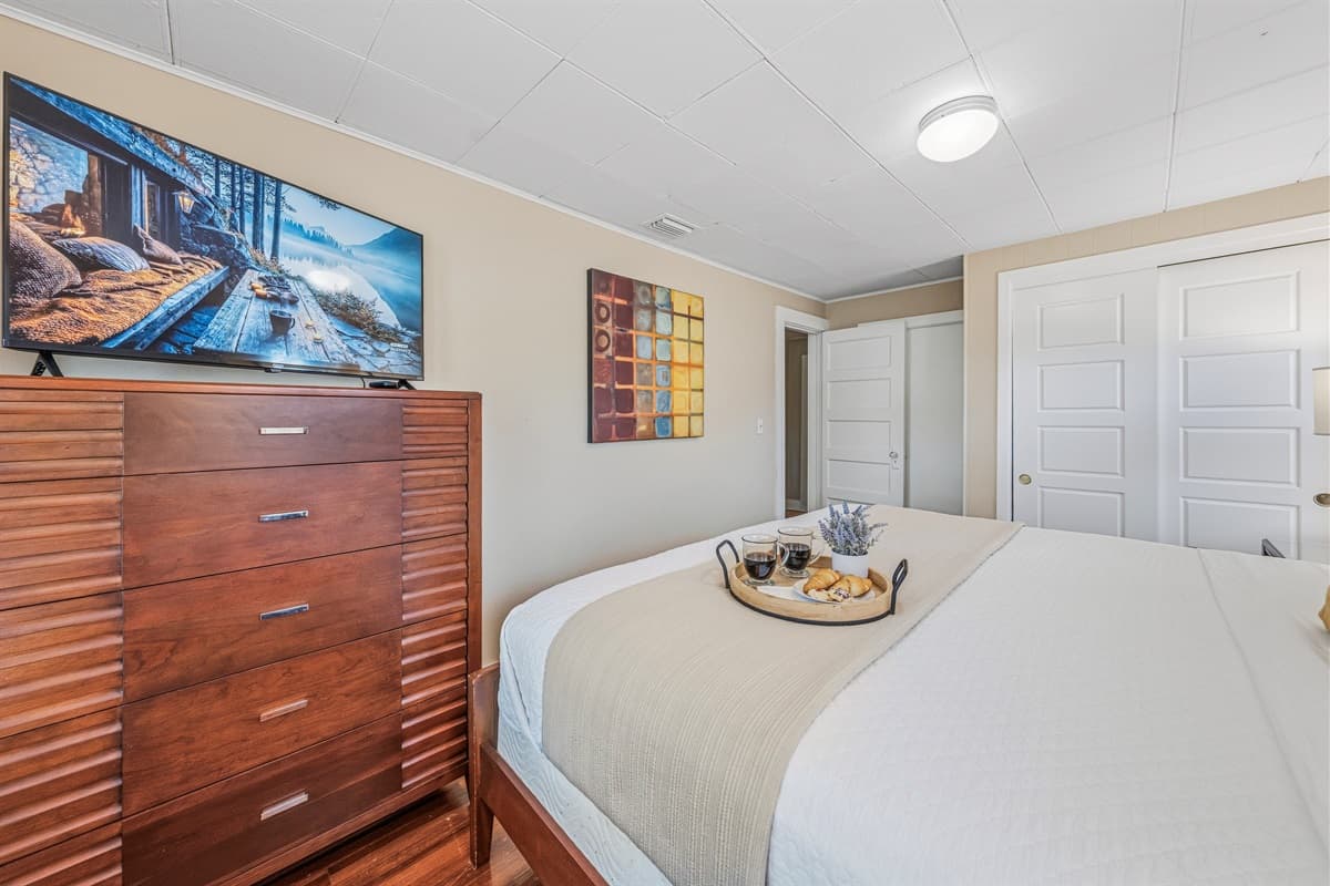 Well-appointed bedroom with ample storage and modern touches.