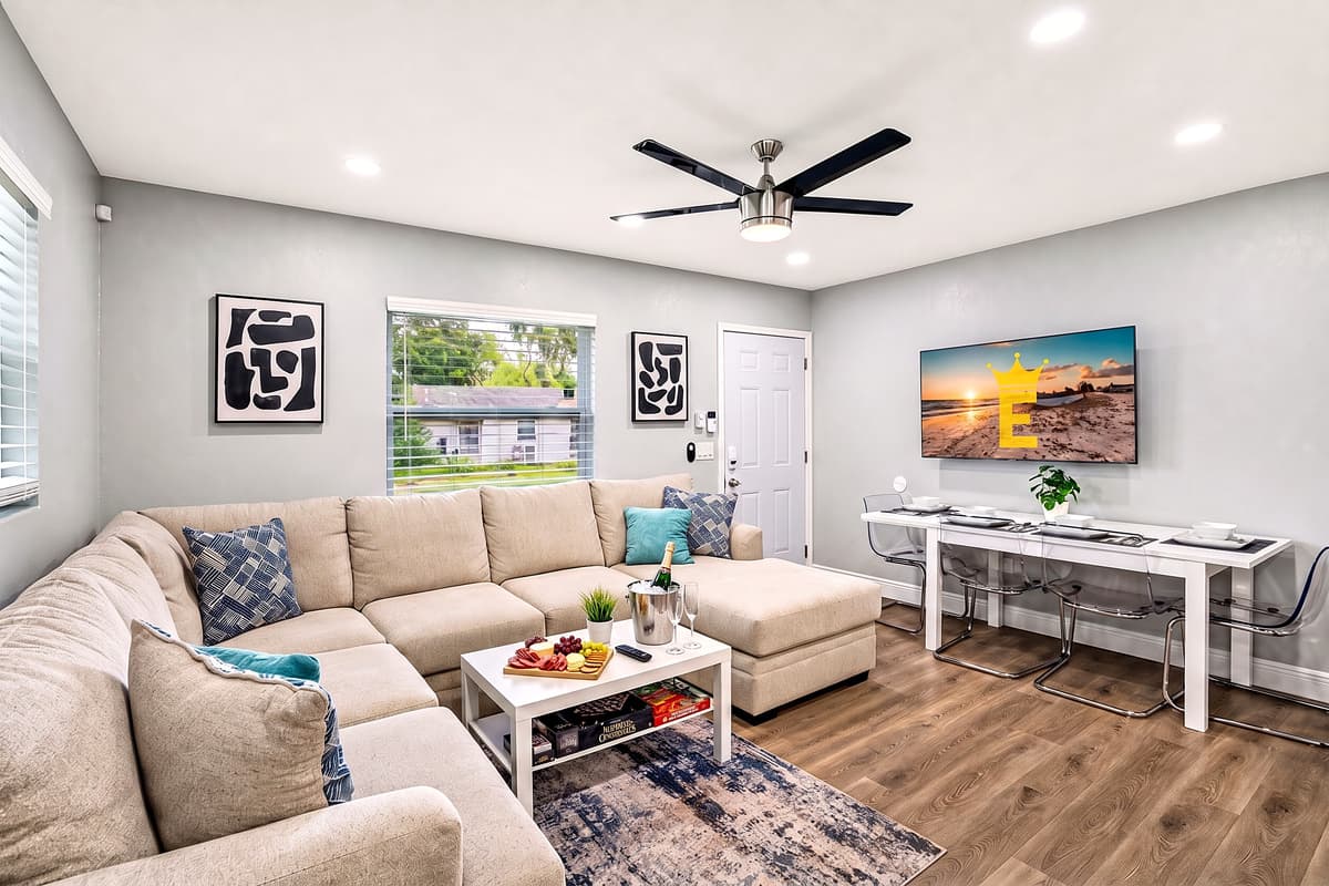 Experience modern comfort in the spacious living room, featuring a large smart flat-screen TV, perfect for streaming your favorite show