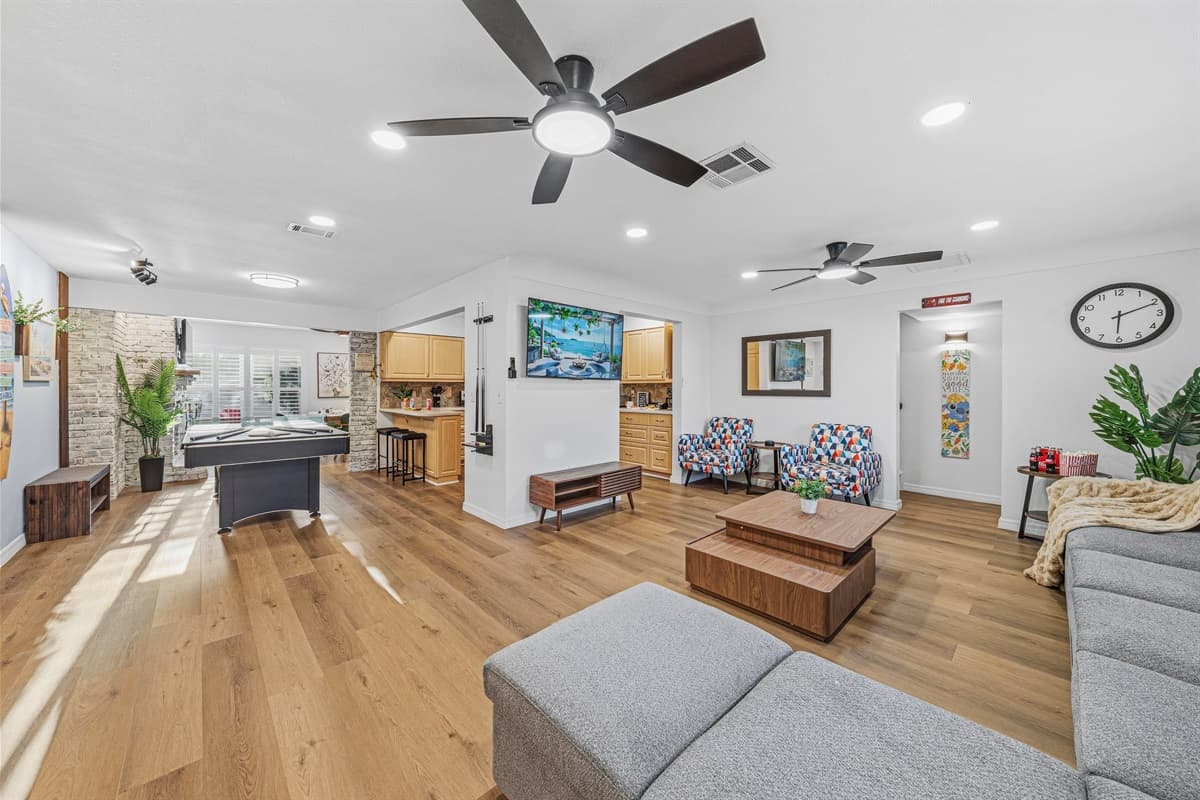 Expansive living area with natural light and seamless flow into dining and entertainment spaces