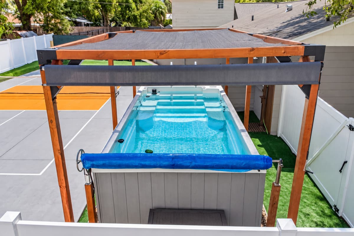 The spacious swim spa features built-in seating and a swim current, making it ideal for both relaxation and low-impact exercise.