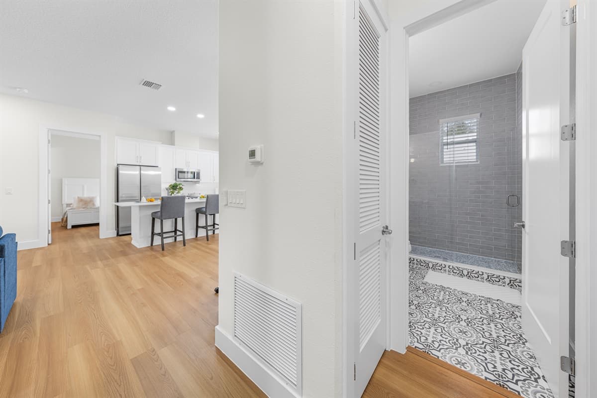 Convenient layout with easy access to a stylish bathroom and open living space, offering comfort and seamless flow throughout the home.
