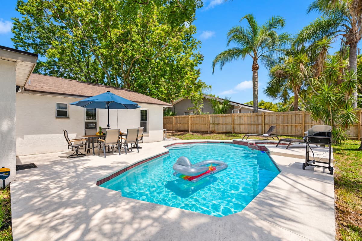 The pool’s pristine surface reflects the blue skies, inviting you to indulge in moments of pure relaxation.