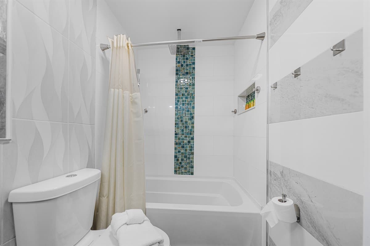 Designed for comfort and convenience, this bathroom features a tub/shower combo and elegant finishes.