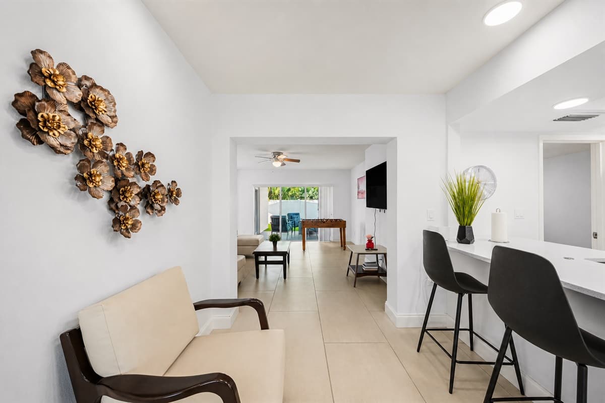 Kitchen area with breakfast bar seating and open-concept layout connecting to the living spaces.