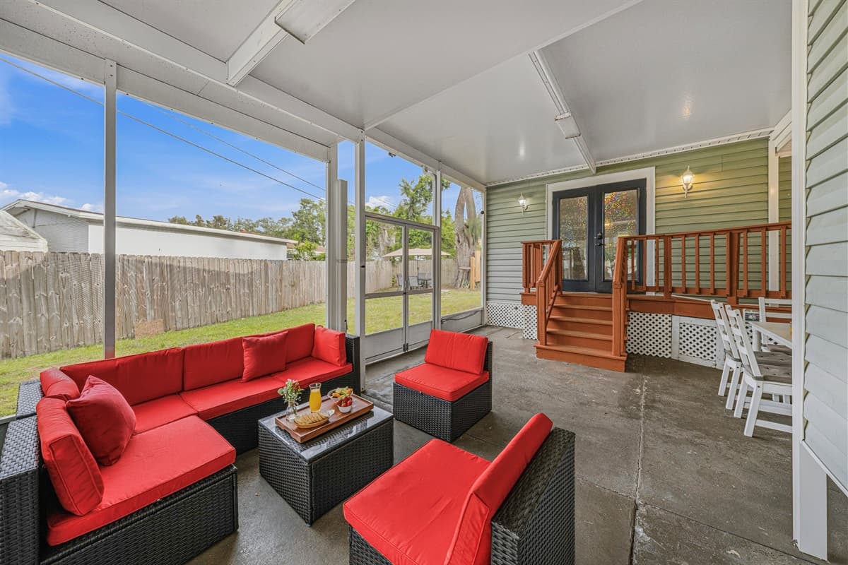 Inviting screened patio with plush seating and easy access to the backyard.