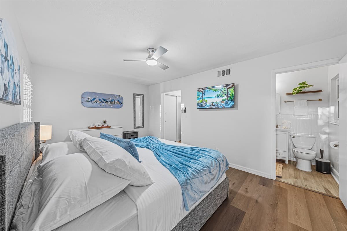 Spacious king bedroom with TV and direct access to an ensuite bathroom for added convenience 