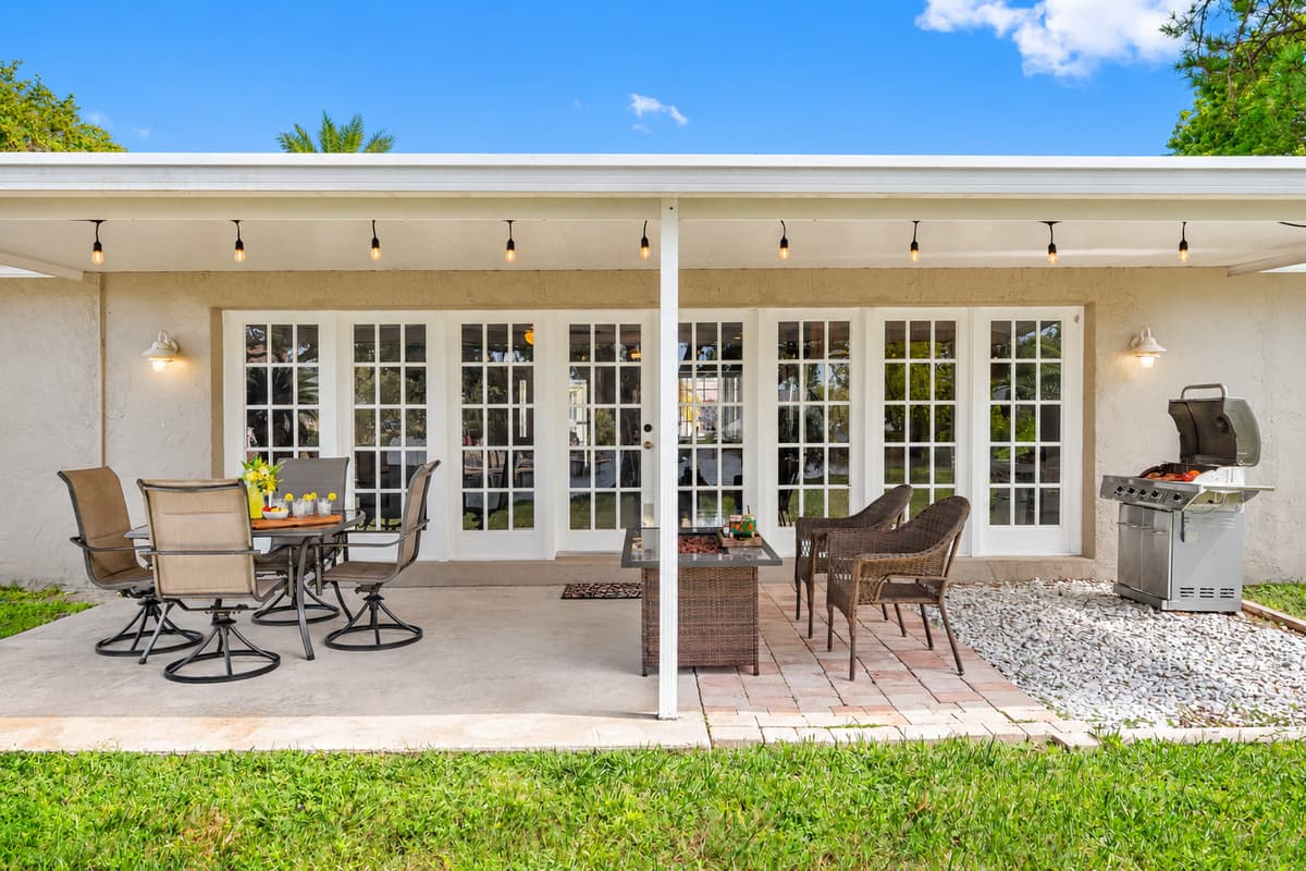Surrounded by verdant landscaping and a gentle waterway, the patio provides a natural backdrop for unwinding and entertaining.