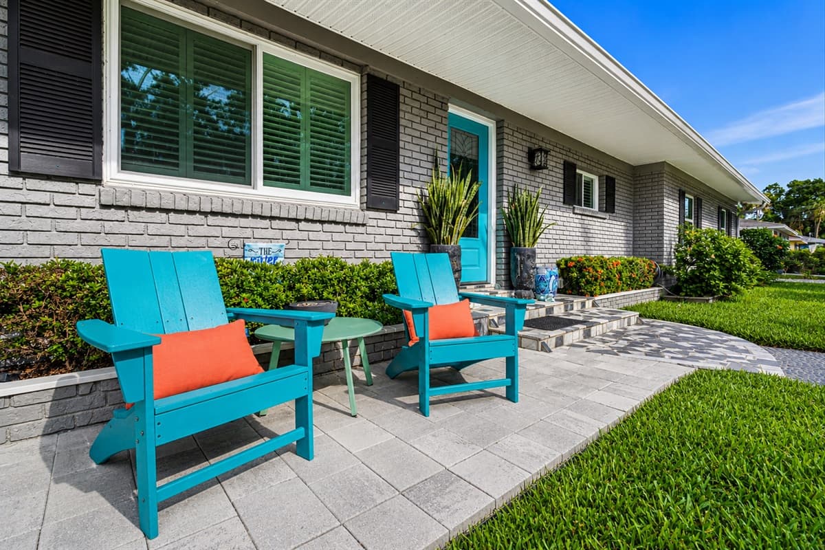 Cozy front patio seating area perfect for enjoying morning coffee or relaxing outdoors.