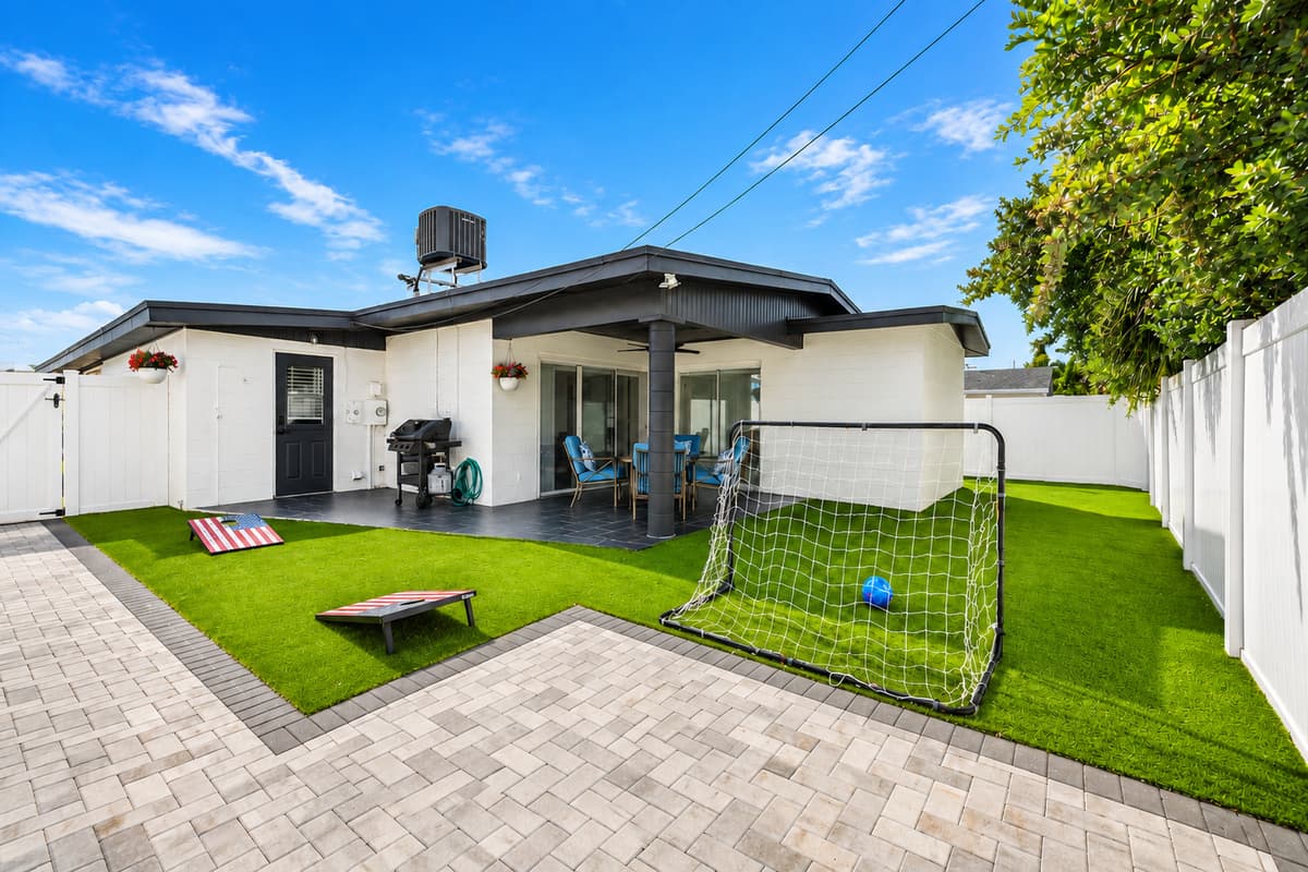Goal posts, cornhole, and nobody watching over you. The turf stays green year-round, so shoes stay clean and the games never stop. Fully fenced and completely yours. This is the backyard kids beg to come back to.
