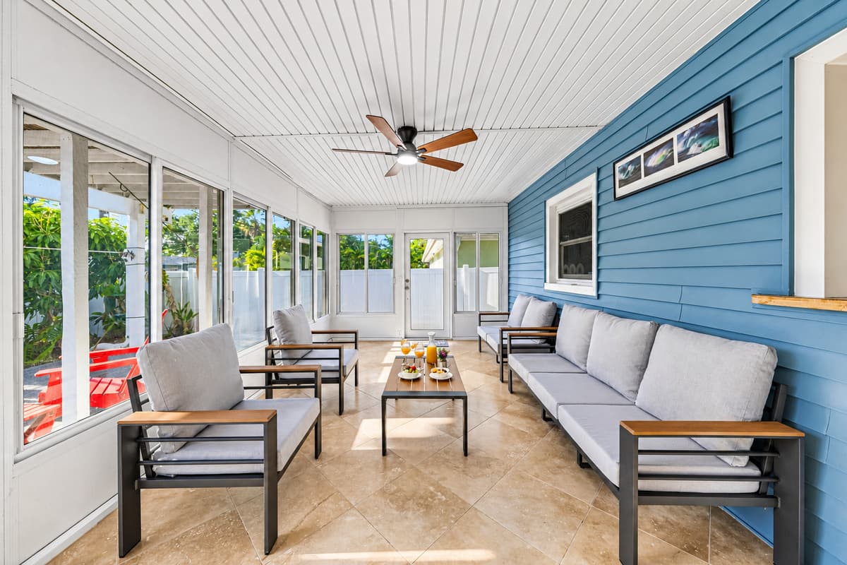 Bright enclosed patio with modern seating and open views—ideal for indoor-outdoor living 