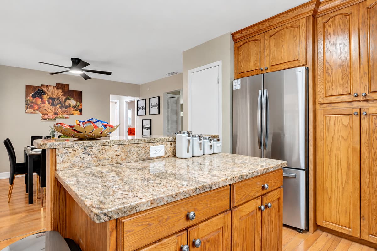 Crafted with solid wooden cabinets, this kitchen exudes a timeless charm while providing ample storage for all your culinary essentials.
