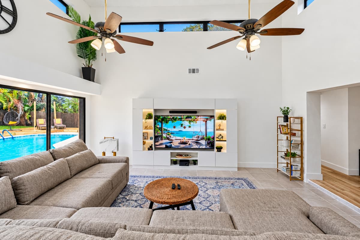 Modern entertainment center with built-in shelving and curated décor.