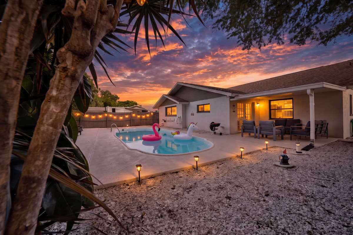 Long after the flights and the sand are forgotten, this is the frame your family will still describe: warm sky, lit pool, string lights over the water, everyone barefoot and no reason at all to go anywhere else tonight.