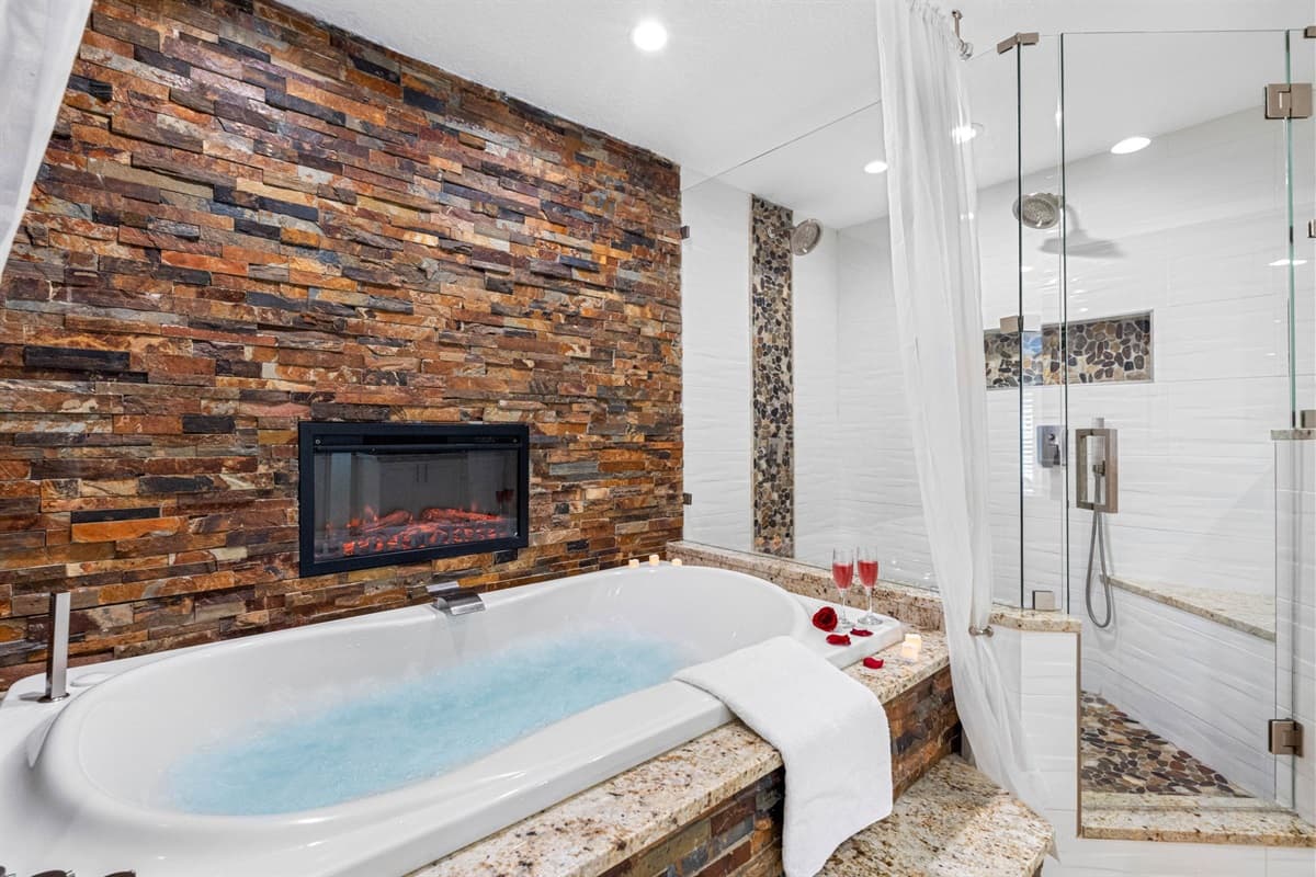 Features a deep soaking tub perfectly positioned in front of a built-in TV.