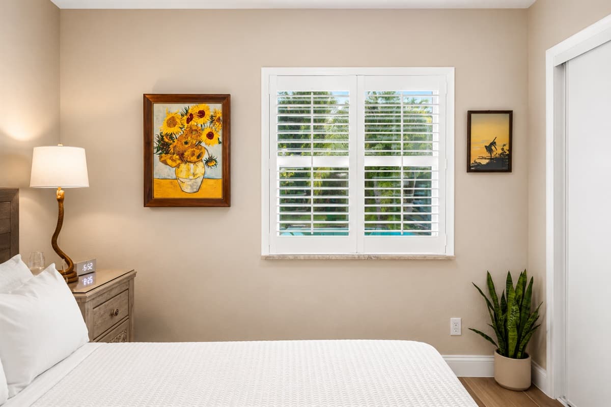 Peaceful bedroom corner showcasing bright windows, cozy bedding, and calming natural light.