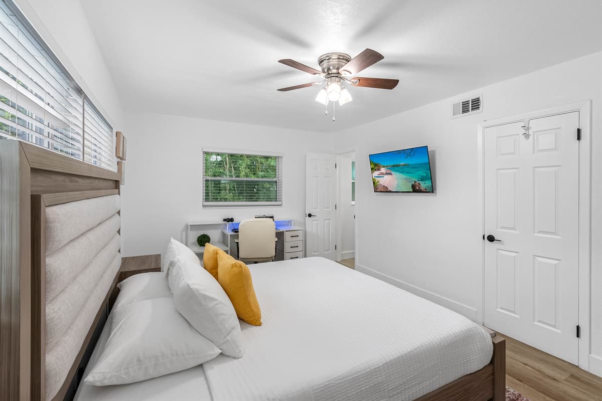 Soft tones, natural textures, and calming accents make this bedroom a cozy retreat after a day of Florida fun.