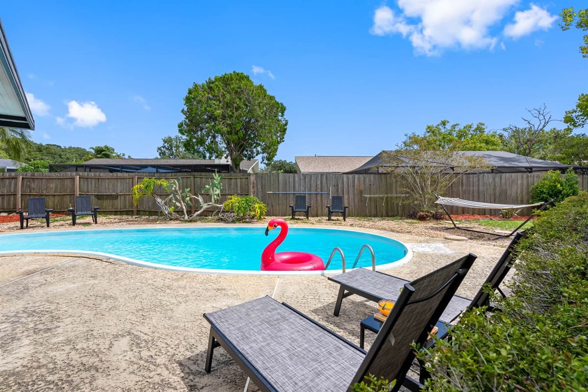 Soak up the Florida sunshine from your fully private backyard oasis! With a sparkling pool, shaded loungers, and lush landscaping, it’s the perfect spot to unwind or make a splash.