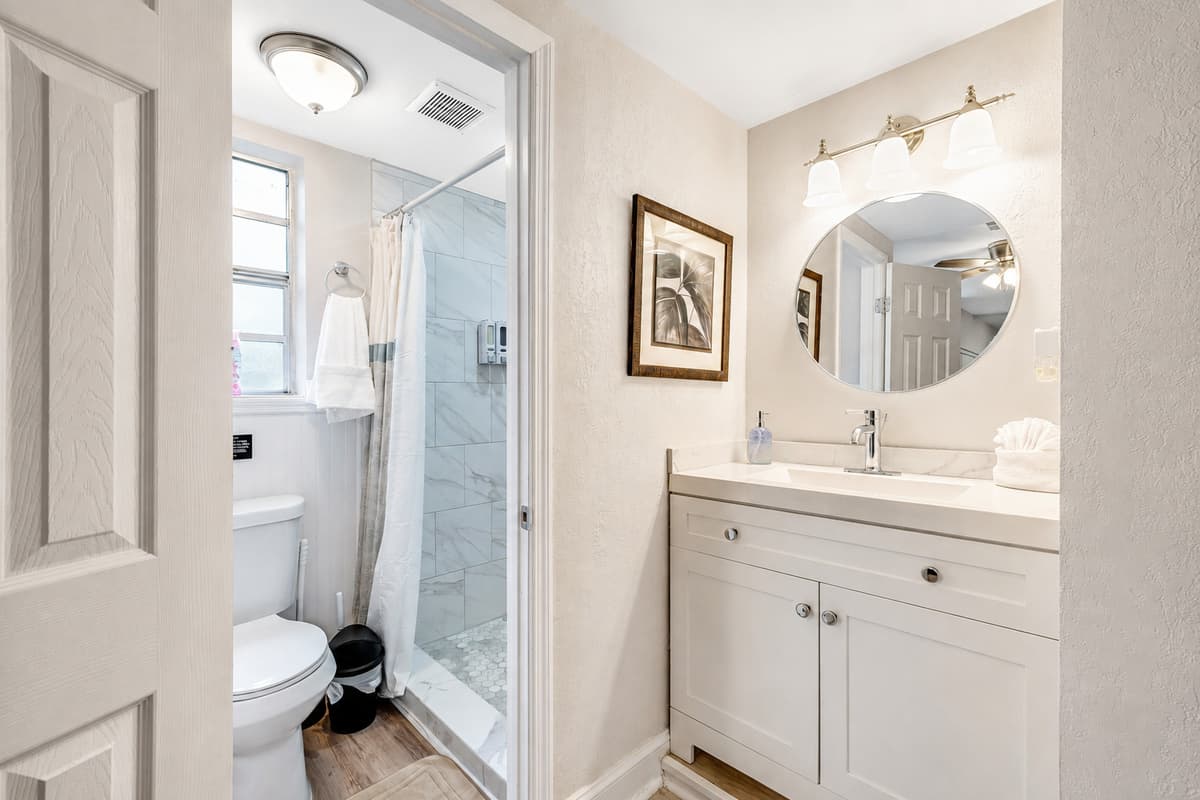 The toilet, discreetly tucked away, ensures your privacy and completes the ensemble of this stylish sanctuary.