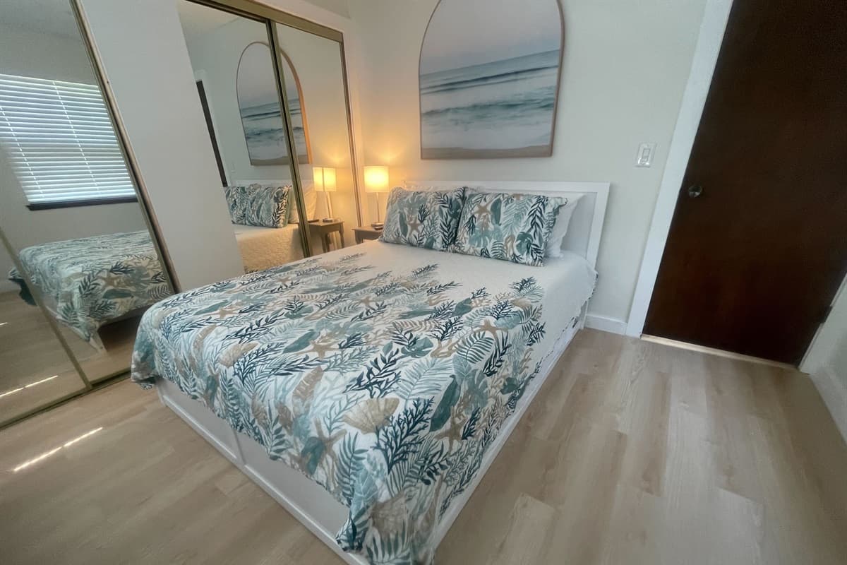 Welcome to our inviting bedroom featuring a cozy queen-size bed. Step into a space designed for comfort and relaxation, where you can unwind and recharge during your stay.