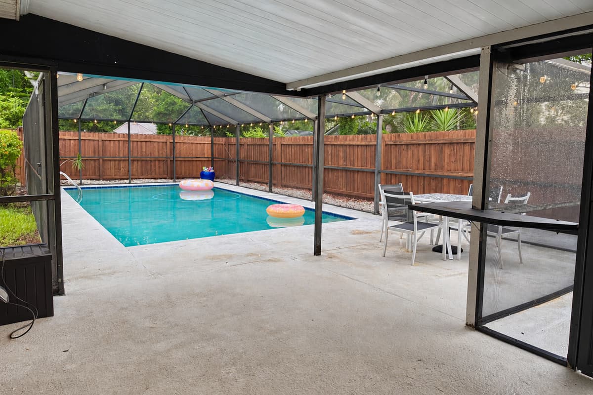 Gather around this stylish patio table for snacks or sunset drinks, all under the protection of a screened enclosure.