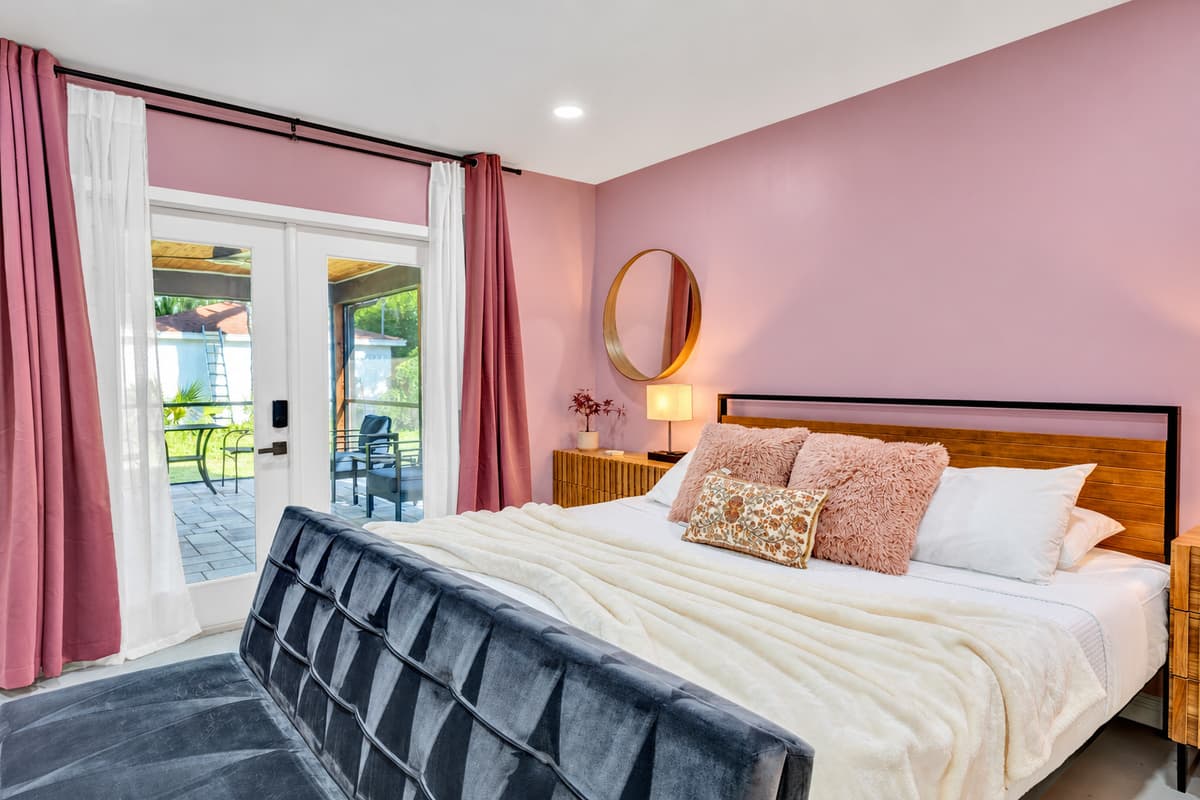King bed, velvet bench, and a full wall of glass you never have to close.