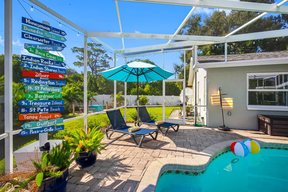 This inviting pool area offers all the charm of a boutique resort, complete with lounge chairs, soft lighting, and tropical landscaping for the perfect vacation vibe.