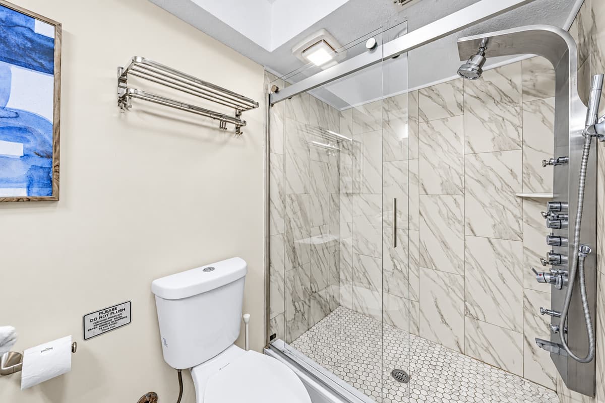 Elegant bathroom with a spacious vanity and beautifully tiled walk-in shower.