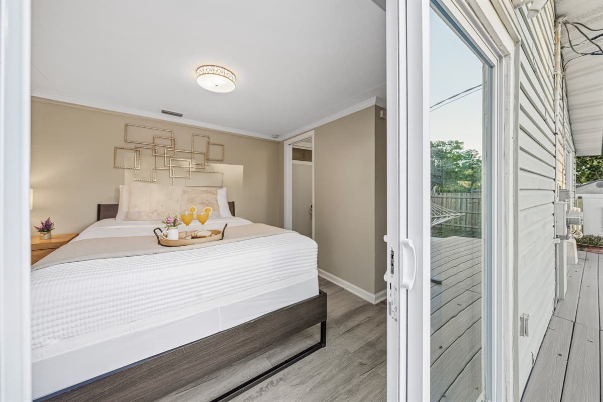 Master bedroom with sliding doors leading directly to the outdoor area.