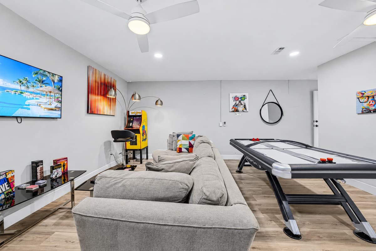 Gather with family and friends in the game room featuring air hockey and a large sectional.