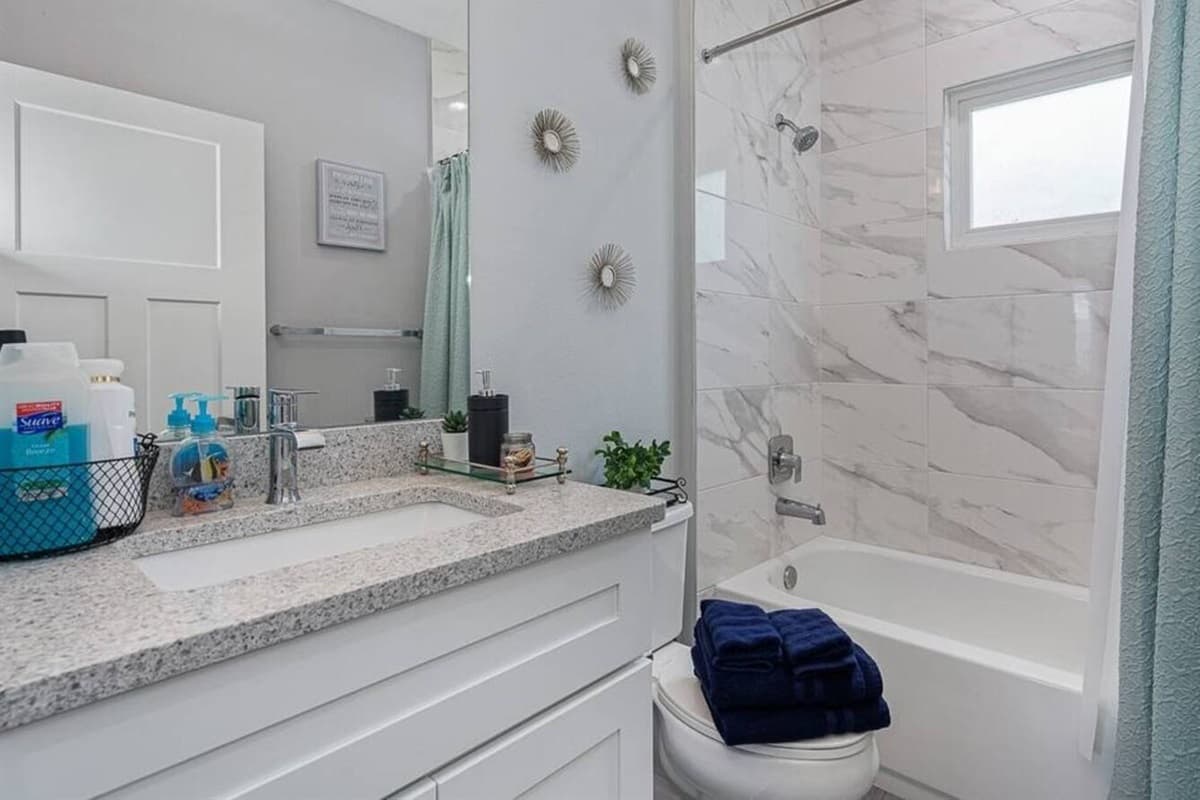 Stunning bathroom with bathtub, sink, toilet and walk in shower.  Enjoy a relaxing bath after a long day of travel from your home to your home away from home. If you like this property, send us a message now!