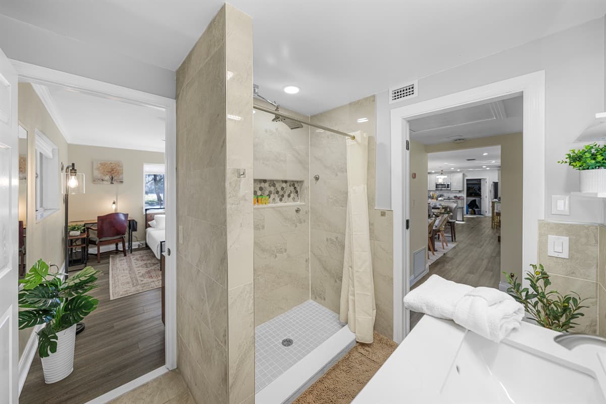 Enjoy a bright and spacious bathroom featuring a sleek vanity, contemporary fixtures, and a clean, calming aesthetic.