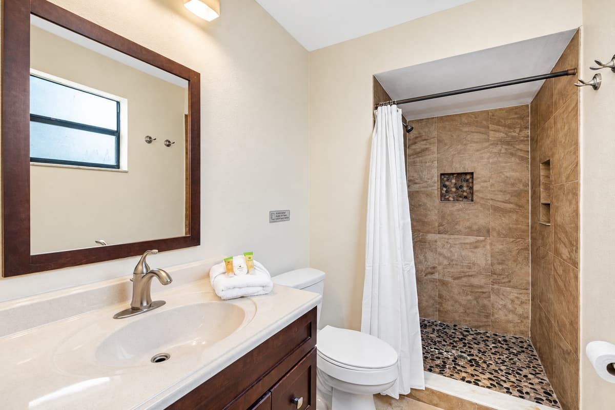This stylish and well-appointed bathroom combines functional design with warm, earthy aesthetics, creating a calming space for freshening up or winding down.