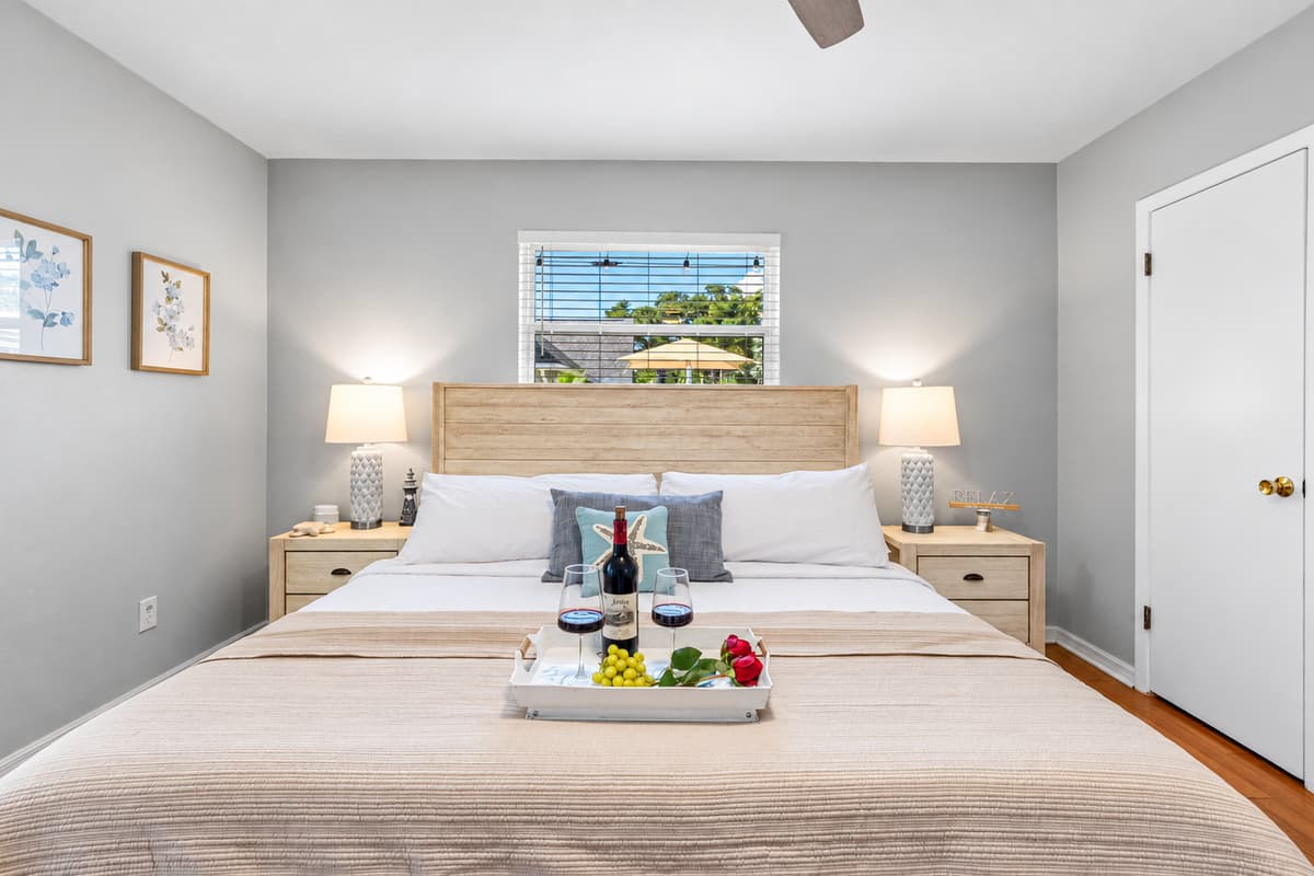 Retreat to the master bedroom, where a plush king mattress, modern ceiling fan, and calming decor invite pure relaxation.