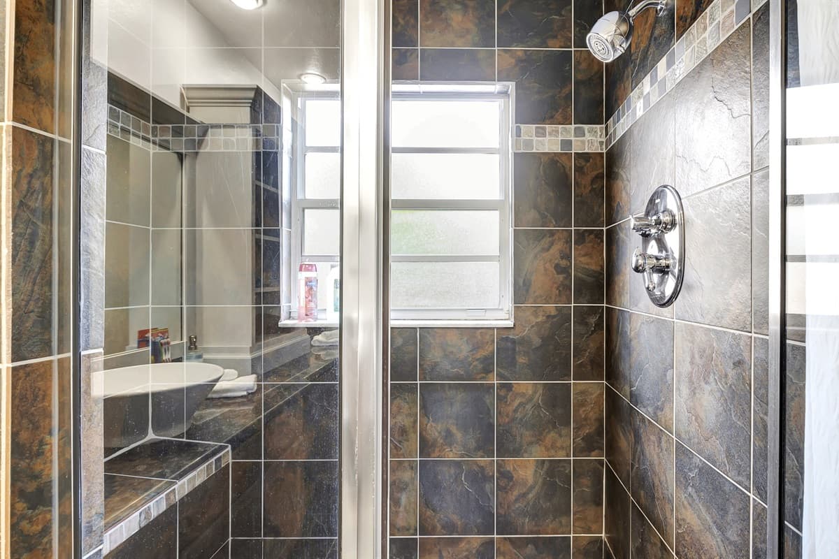 Unleash the power of functionality with a sleek toilet and indulge in the luxury of a spacious walk-in shower.