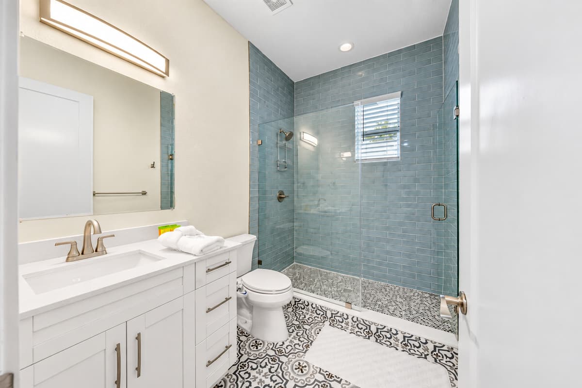 Modern bathroom with sleek vanity and walk-in shower.
