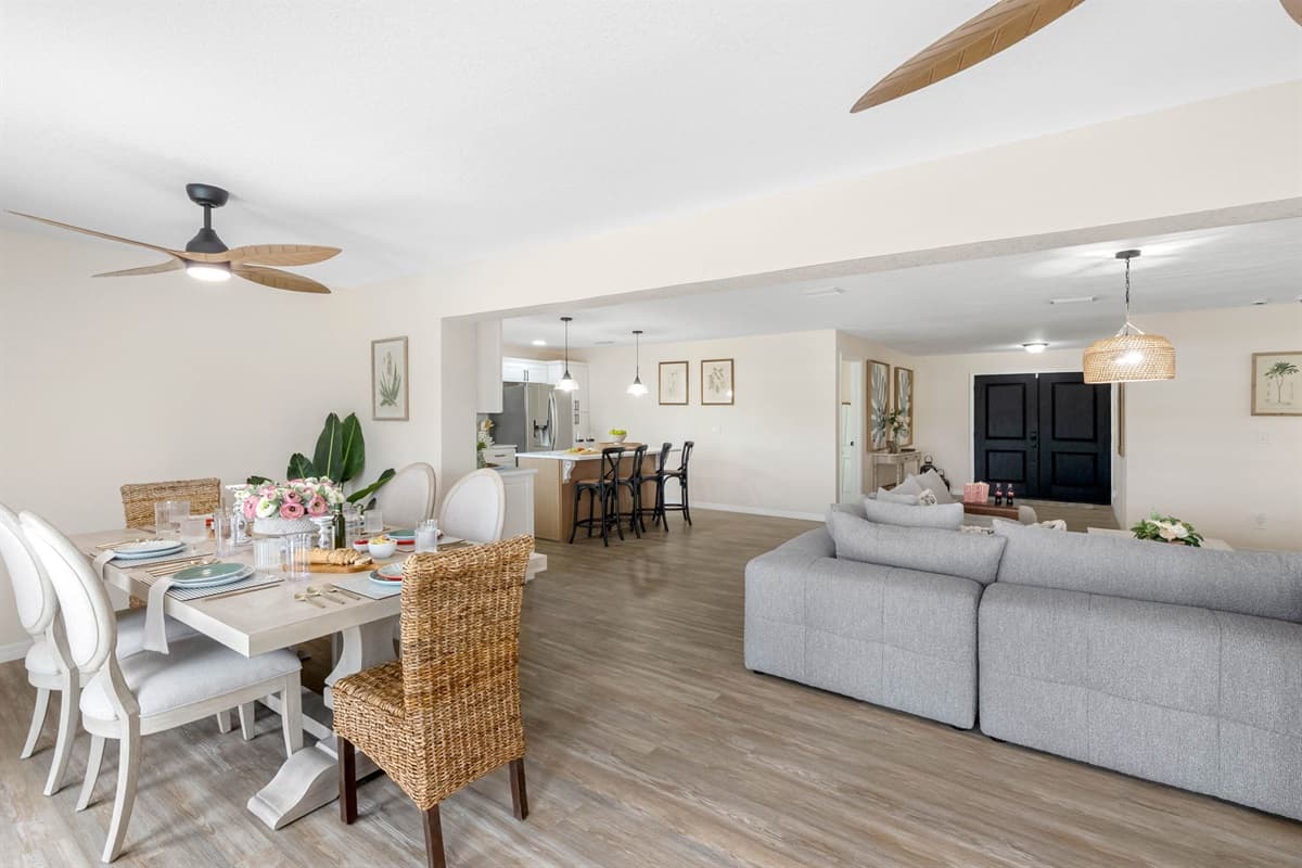 The mix of upholstered and woven chairs adds both comfort and character, creating a space that feels welcoming for families and groups.
