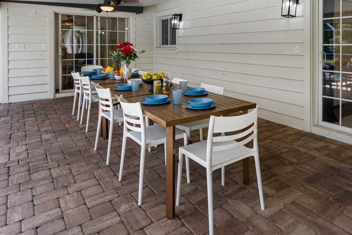 Featuring an extended dining space and poolside seating, this screened enclosure is perfect for both quiet mornings and lively evenings.