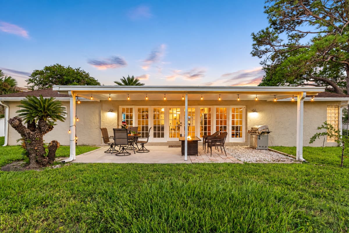 With a spacious table and comfortable chairs under a covered roof, this patio invites you to savor meals outdoors while protected from the elements.