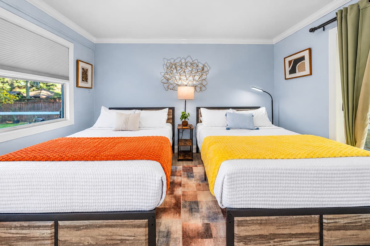 Designed for shared comfort, this bedroom offers two double beds with plush linens and a bright, welcoming atmosphere.