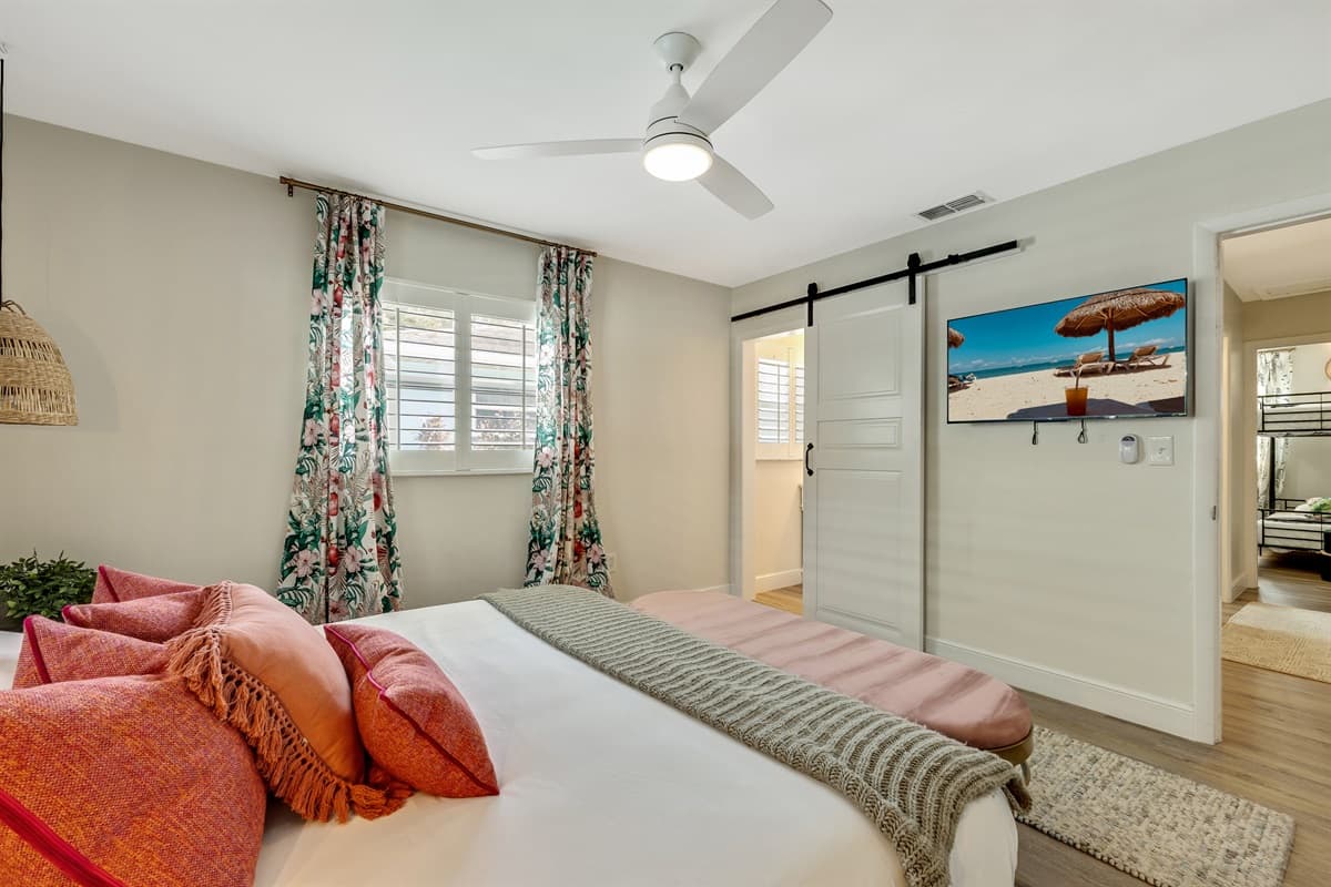 The bed is dressed in sumptuous linens, with pillows arranged meticulously to offer both support and a touch of opulence.